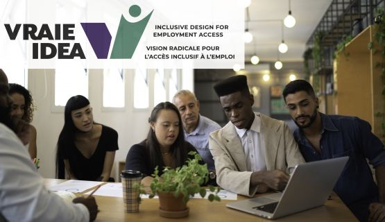 A group of workers in a well-lit office; the logo for VRAIE/IDEA is on the top left corner
