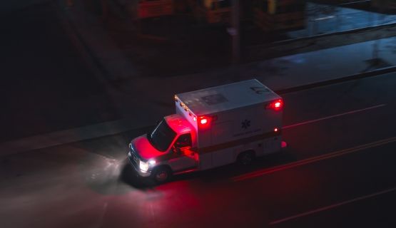 An overhead view of an ambulance driving at night.