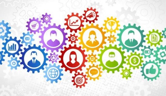 Colourful gears and various icons depict multiple connections within a system