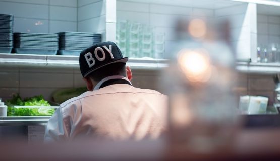 The back of a cook in a restaurant kitchen