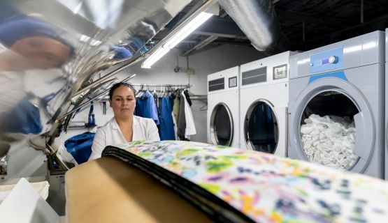 A woman works at a laundry service
