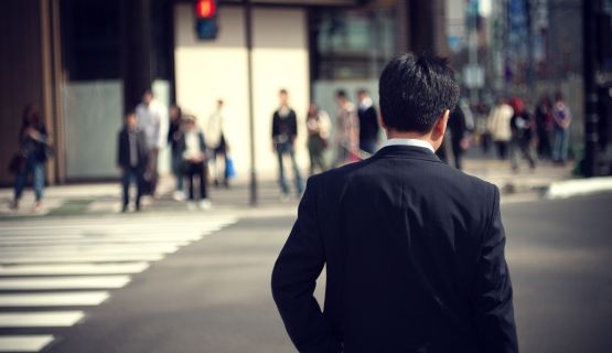 View from the back of a man in a suit in an urban street