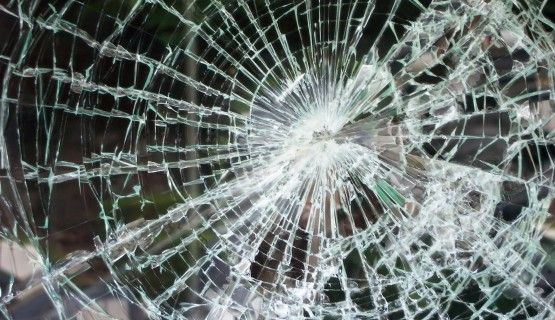 Close-up image of shattered glass window