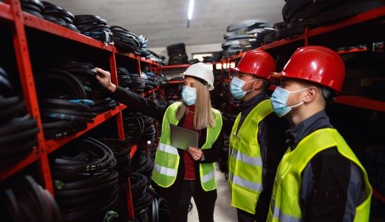 Workplace inspectors inspecting a workplace during COVID, as indicated by the masks they are wearing