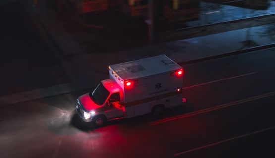 An overhead view of an ambulance driving at night.