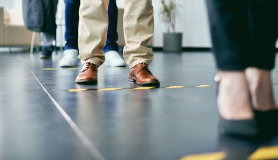 Close-up of floor markings indicating six feet distances