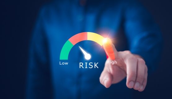Close-up of a faceless worker indicating risk levels along a spectrum