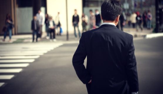 View from the back of a man in a suit in an urban street