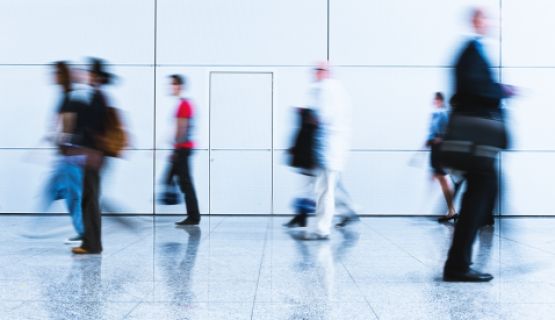 Blurred figures of workers walking