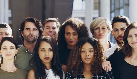 A group of young adults look into the camera