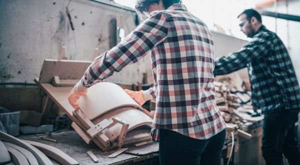 Young couple working at their small woodworking business